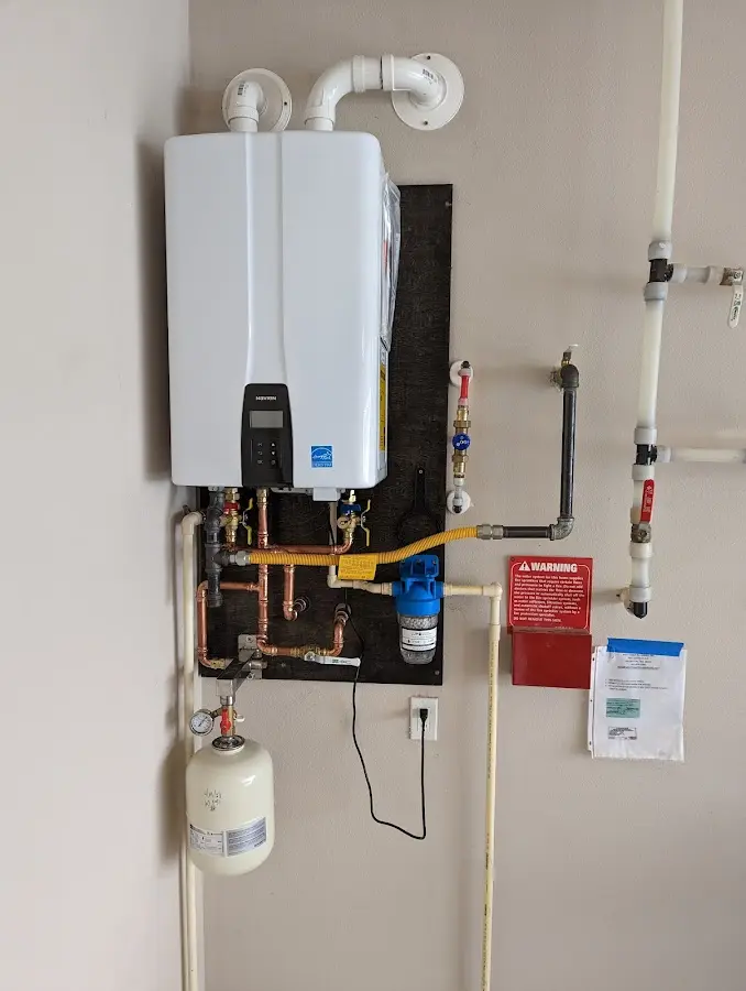 Professional plumber installing copper piping in a Bondurant home